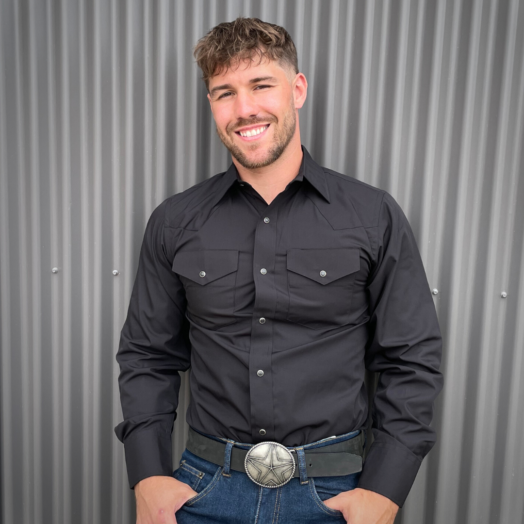 Men's long-sleeve western shirt. Western shirt is black with two front pockets and pearl snap buttons.