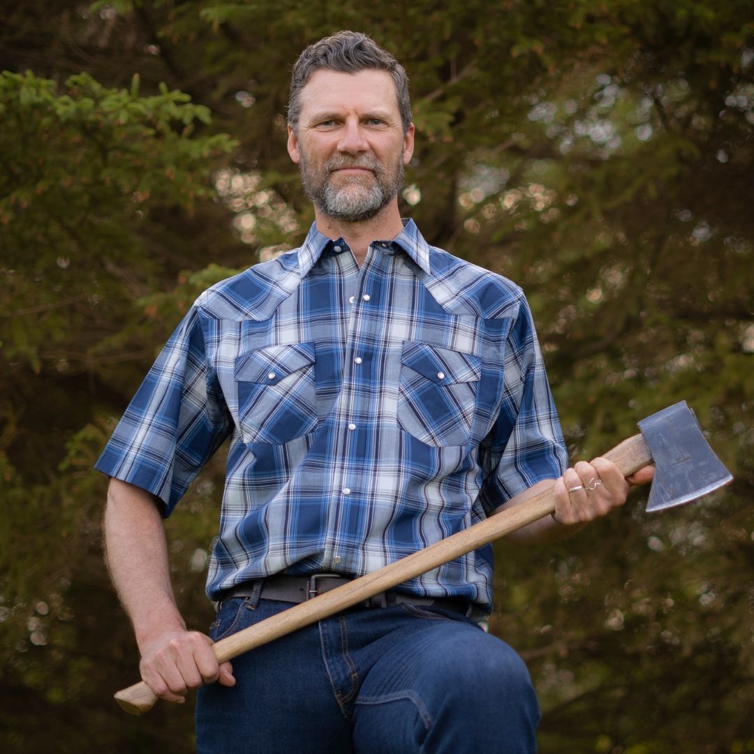 Men's short-sleeve plaid western shirt. Western shirt is blue & white with pearl snaps.