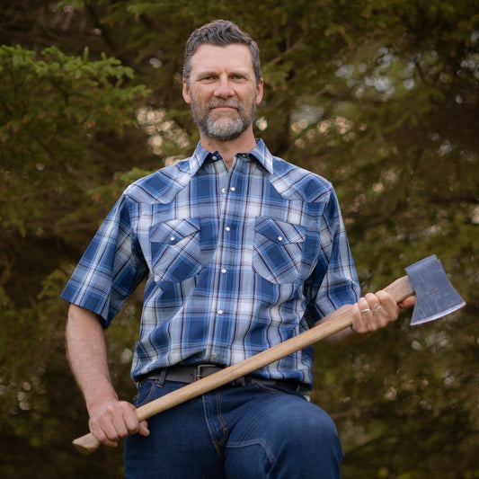 Men's short-sleeve plaid western shirt. Western shirt is blue & white with pearl snaps.