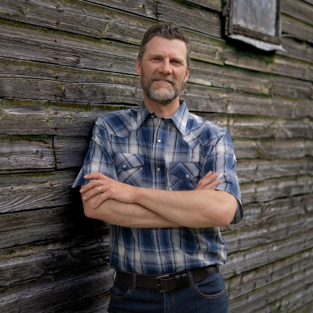 Men's short-sleeve plaid western shirt. Western shirt is blue & white with pearl snaps.
