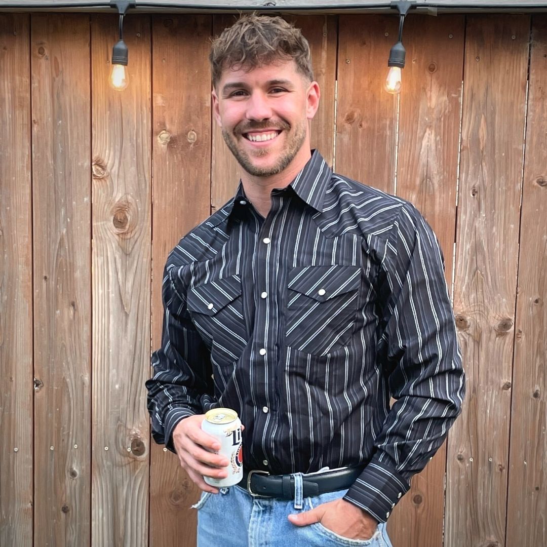 Men's long-sleeve stripe western shirt. Western shirt is black with white stripes and pearl snap buttons.