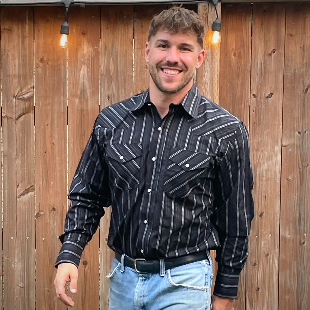 Men's long-sleeve stripe western shirt. Western shirt is black with white stripes and pearl snap buttons.