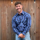 Men's long-sleeve stripe western shirt. Western shirt is blue with black stripes and has pearl snap buttons.
