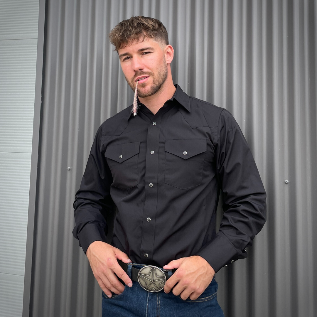 Men's long-sleeve western shirt. Western shirt is black with two front pockets and pearl snap buttons.