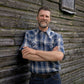 Men's short-sleeve plaid western shirt. Western shirt is blue & white with pearl snaps.