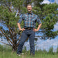 Men's short-sleeve plaid western shirt. Western shirt is teal, black and white with pearl snaps.
